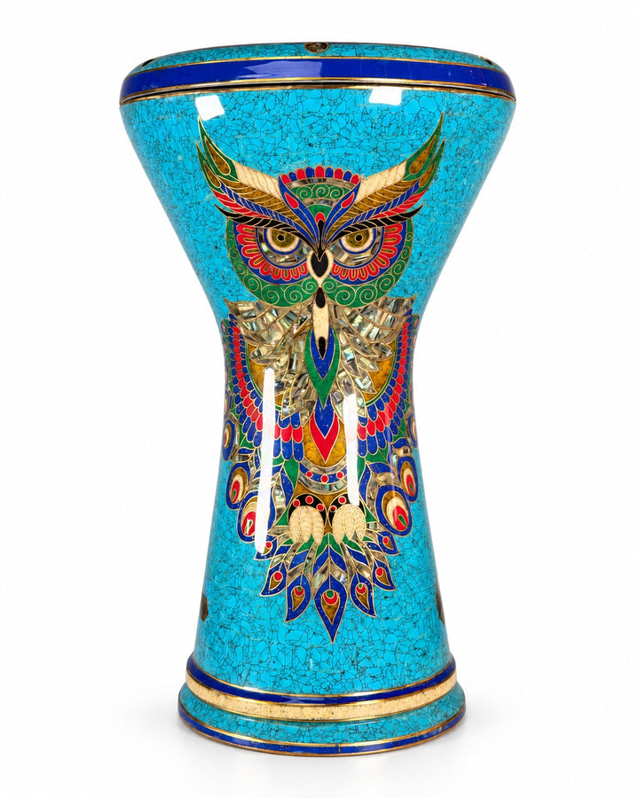 Sala Azure Owl Sombaty darbuka standing upright, showing a colorful owl motif on turquoise mosaic with deep-blue borders.