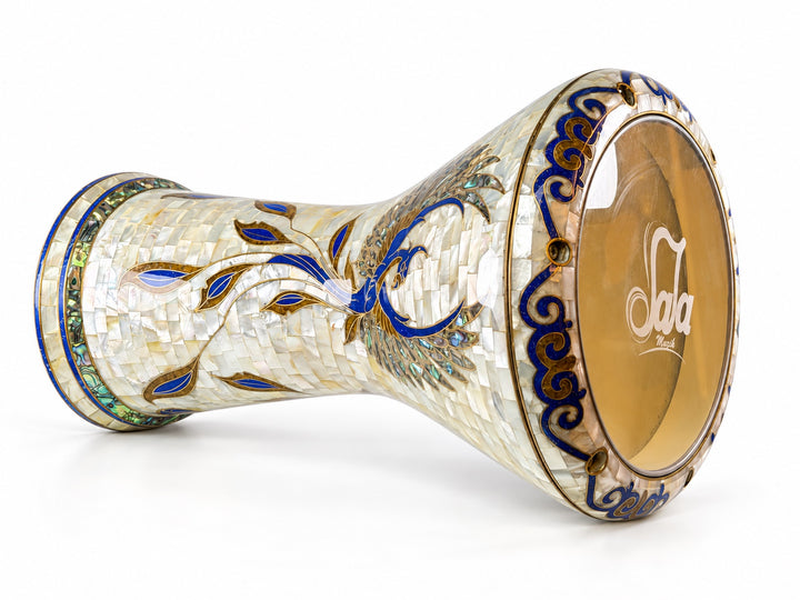 Sala Phoenix Pearl Sombaty darbuka on its side, showing the Sala-branded drumhead and a sweeping blue-and-gold bird motif on pale mosaic.